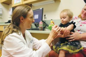 Dr. Sarah Mulkey performs a follow-up neurologic exam on a one-year old infant with neonatal hypoxic-ischemic encephalopathy.