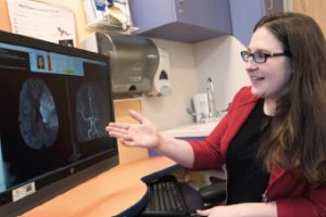 Dr. Laura Lehman examines the neuroimaging studies of a child with stroke.