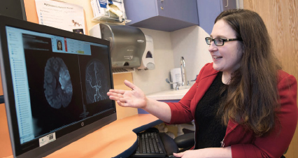 Dr. Laura Lehman examines the neuroimaging studies of a child with stroke.